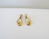 Vintage gold metal up side down heart shaped earring.