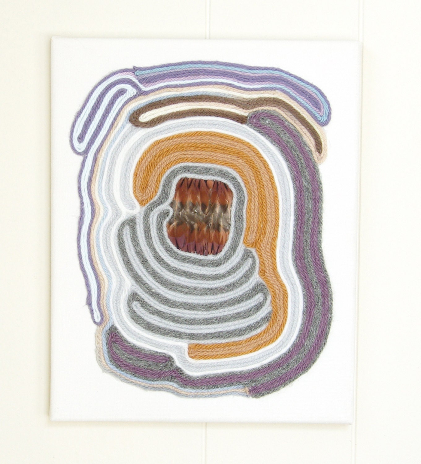 pheasant feather Aztec Huichol culture inspired yarn painting in rust/grey/black/gold