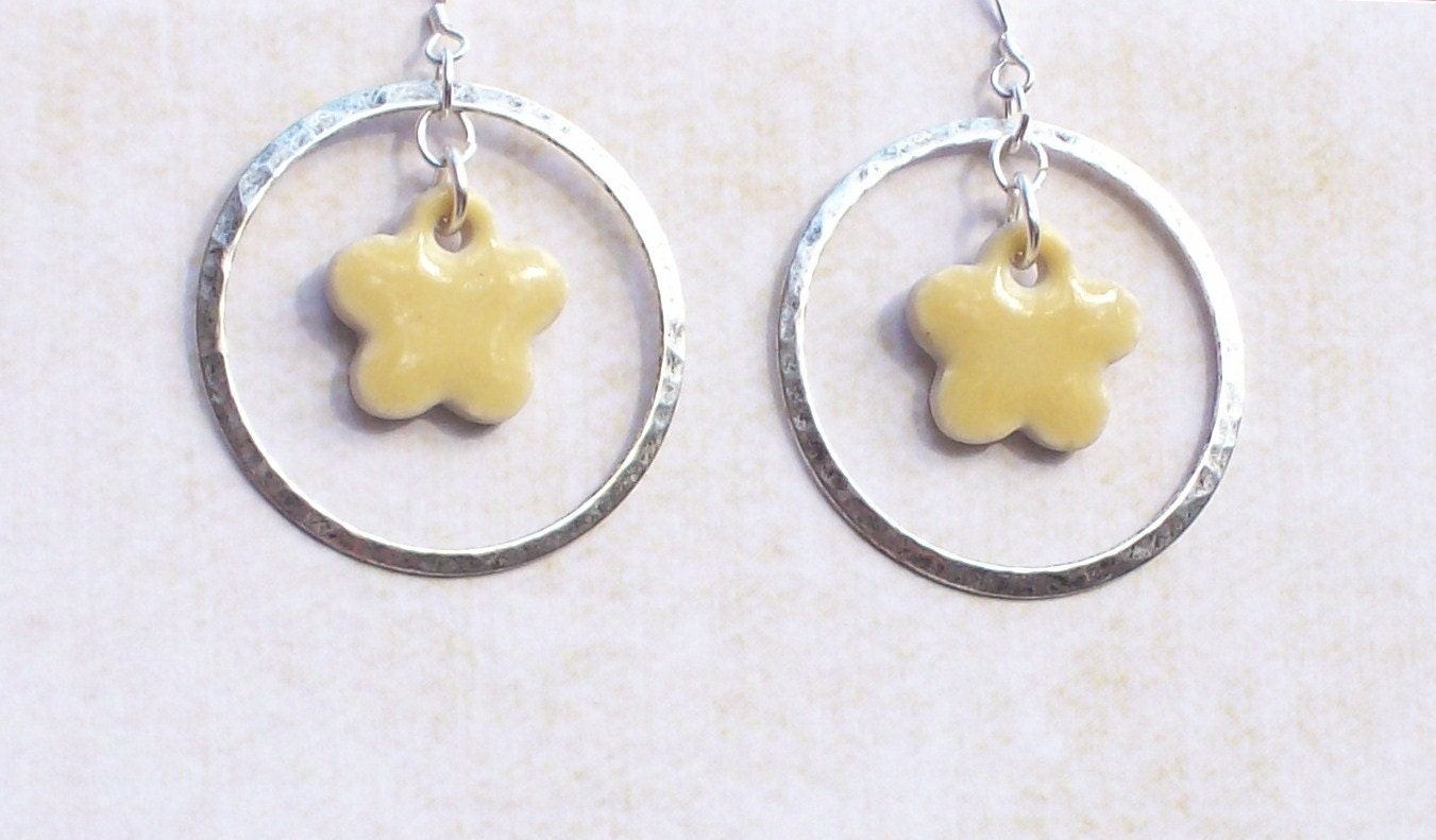 Silver hoop earrings with yellow clay flower