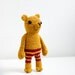 Crocheted amigurumi, soft toy, soft sculpture - Pete the bear with red-yellow striped pants