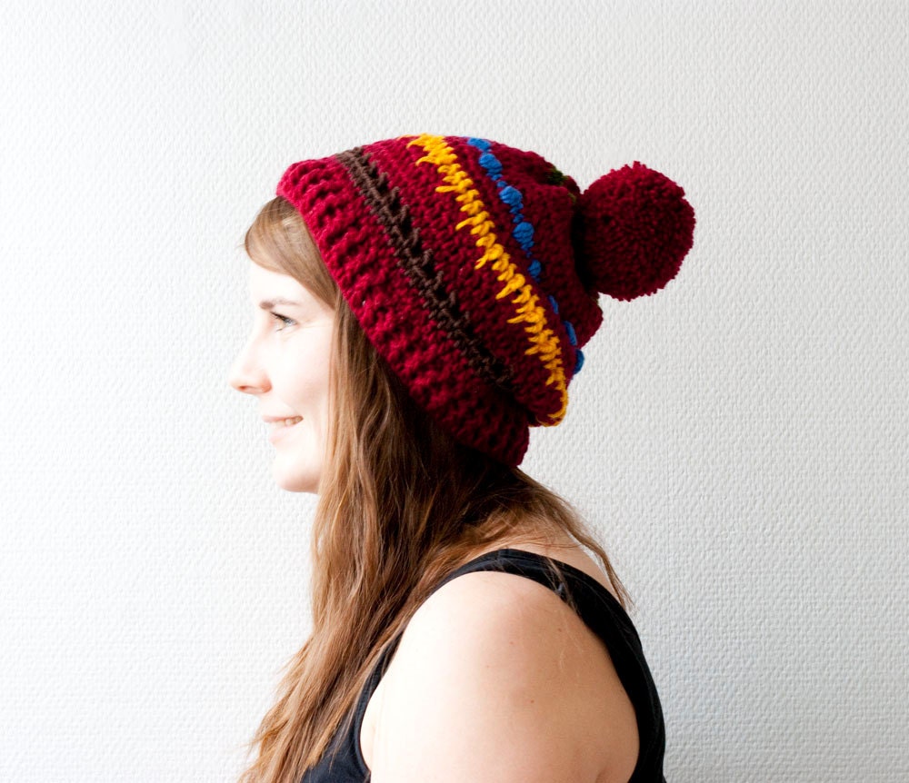 The slouchy boho wool hat in oxblood marron dark red with stripes in green, blue, yellow and brown