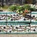 Upcycled mosaic herb garden planter with olive branch pattern