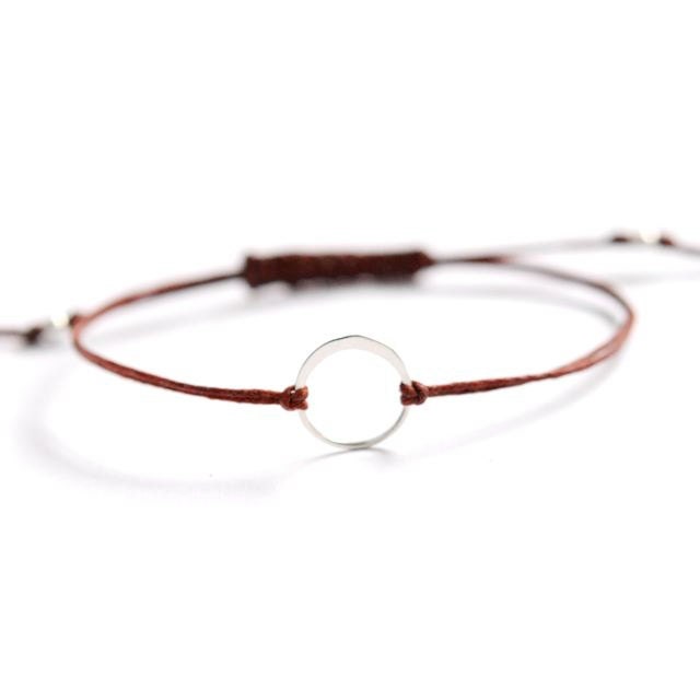 sterling silver karma circle bracelet on Rust Irish linen