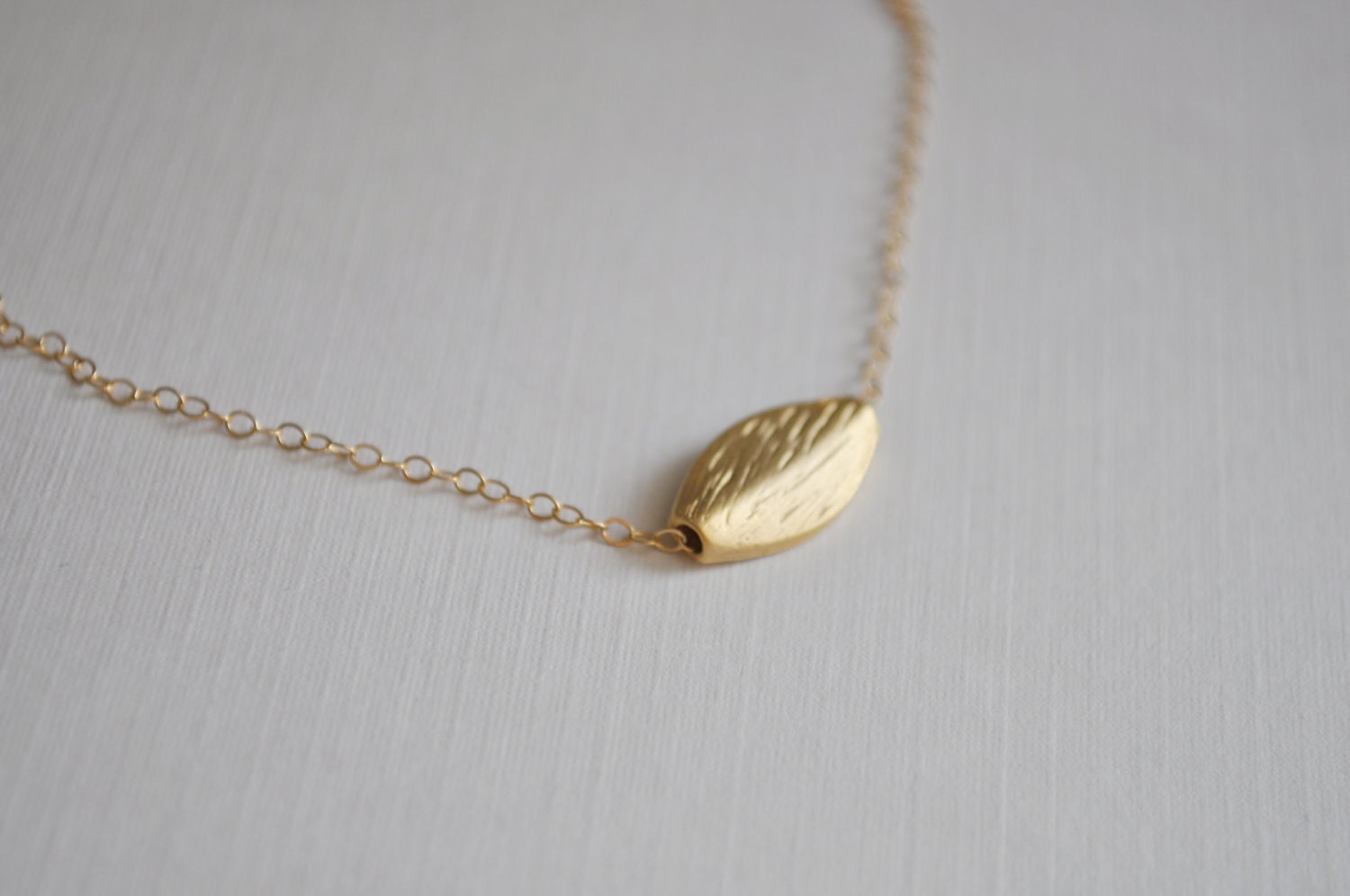 Gold Leaf Necklace - small leaf charm gold plated etched oval bead - simple everyday jewelry - adenandclaire