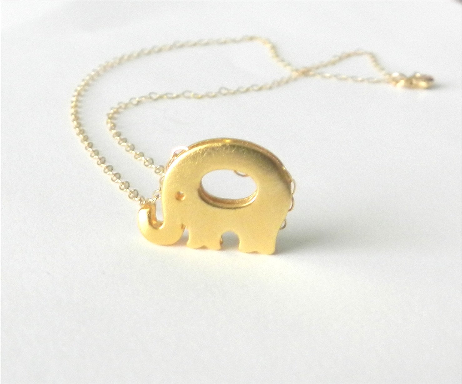 Tiny elephant necklace in gold, lucky little elephant, delicate modern jewelry
