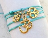 Teal Silk Ribbon Wrap Bracelet With Om Peace Sign And Hamsa Charms
