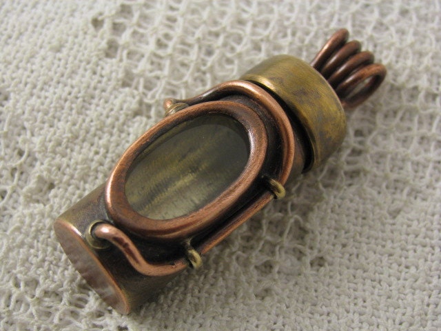 Waterproof pill bottle pendant. relic holder. Screw on cap. Brass, copper and glass. Reliquary
