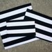 Oversized Black and white striped zippered clutch.