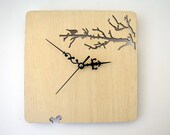 Wood wall clock. Branches and bird