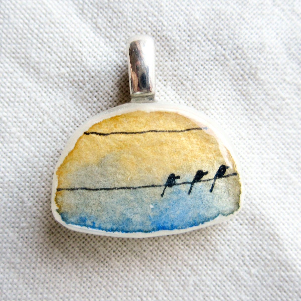 Rounded Pendant Charm with A Trio of Birds on wires (ochre yellow sky, blue clouds) P146