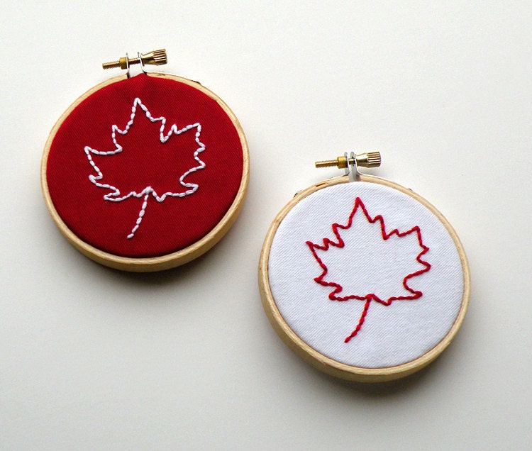 Two embroidered maple leafs in 3" wood embroidery hoops