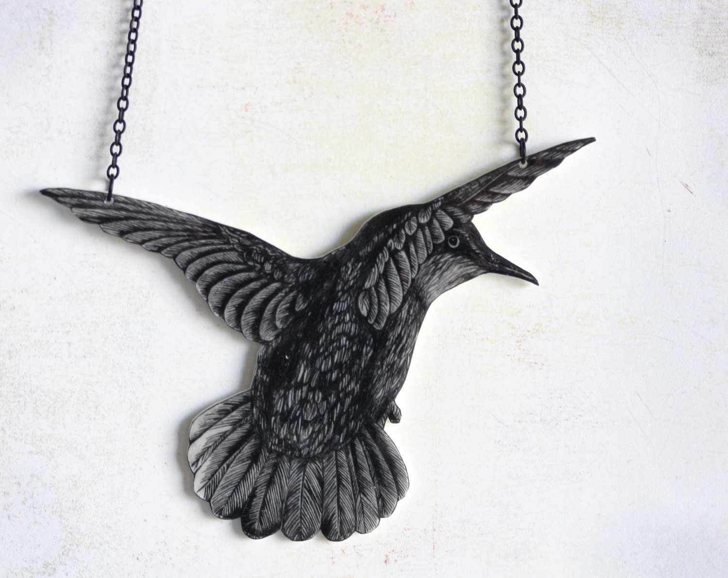 Hummingbird -pendant, drawing on plastic