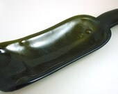 Recycled green wine bottle slumped into curved serving dish