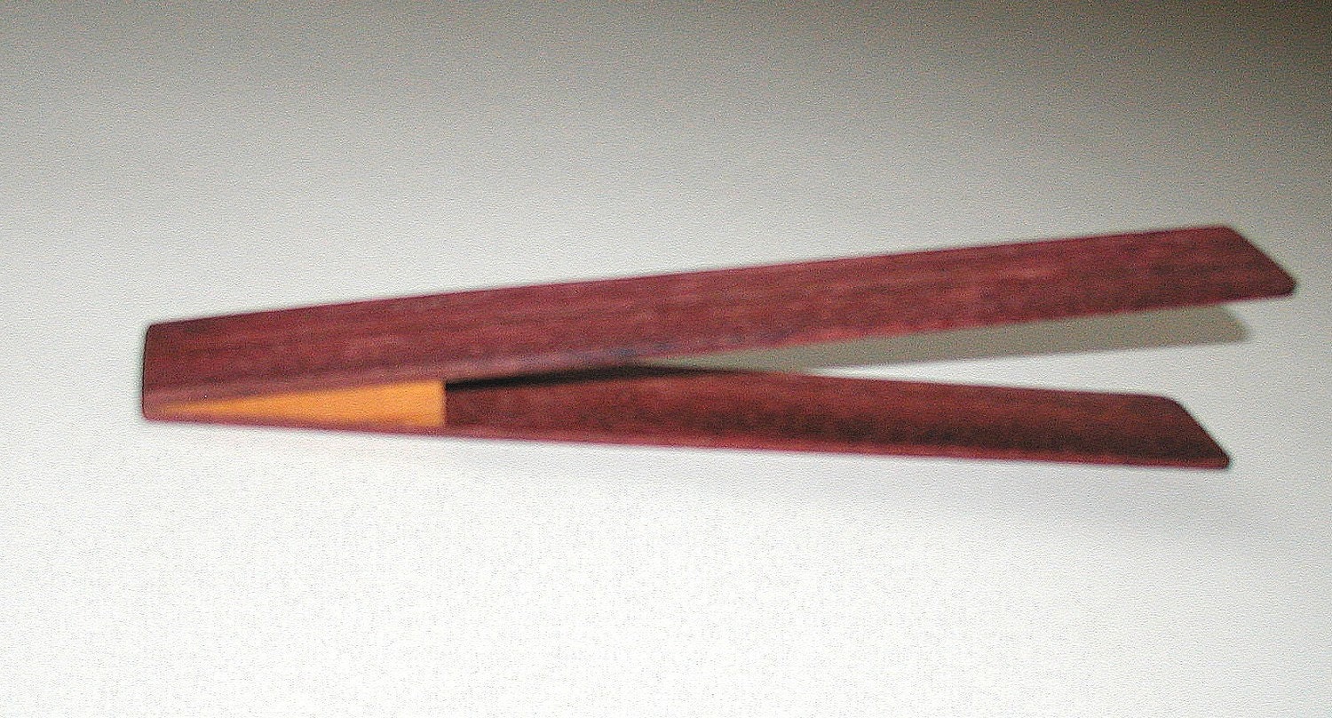 slice of bread board and toast tongs