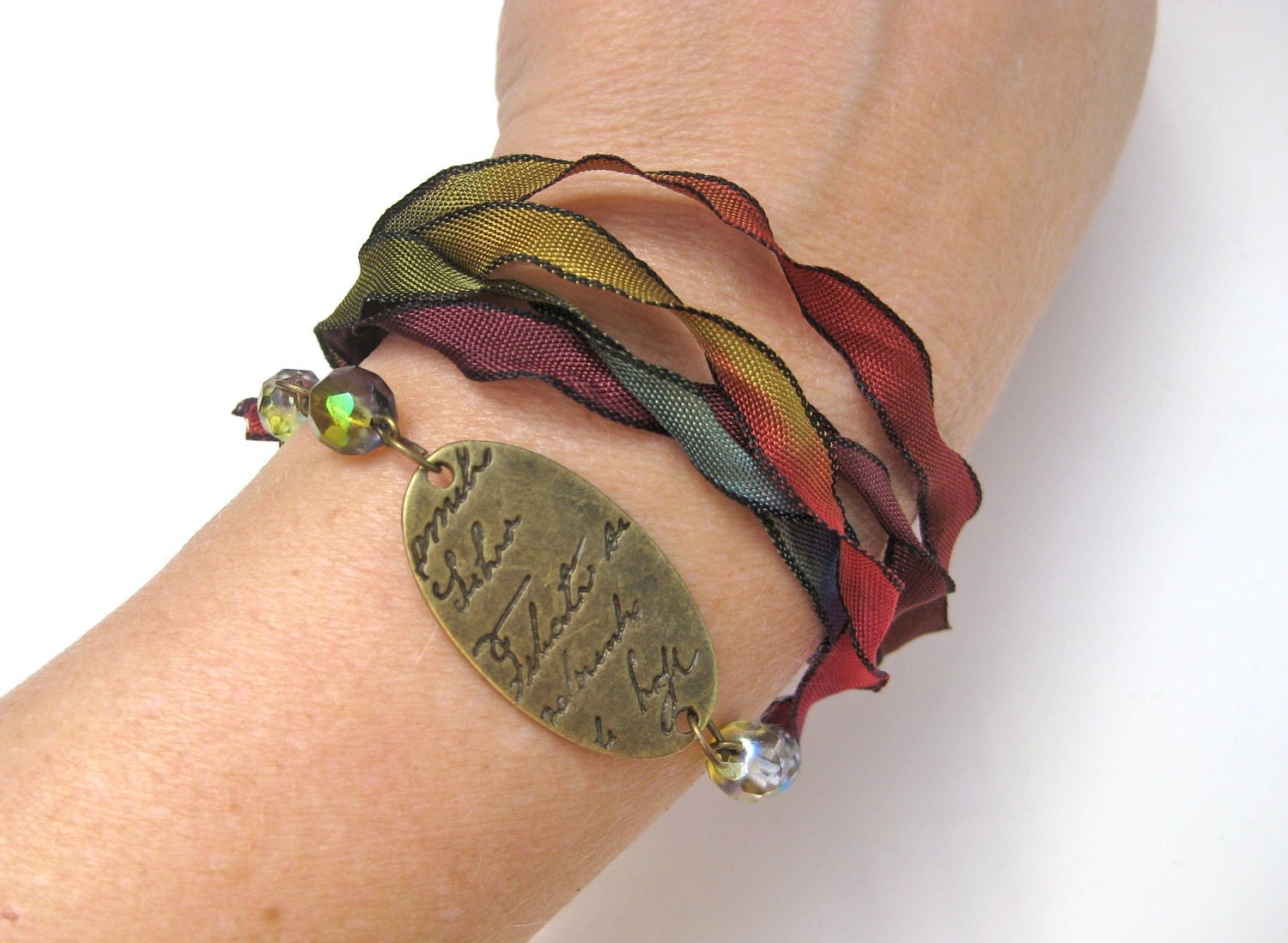 Poetry - Romantic ribbon bracelet in purples, greens, reds, and rusts featuring an antique brass charm with beautiful script - CheekyChickDesigns