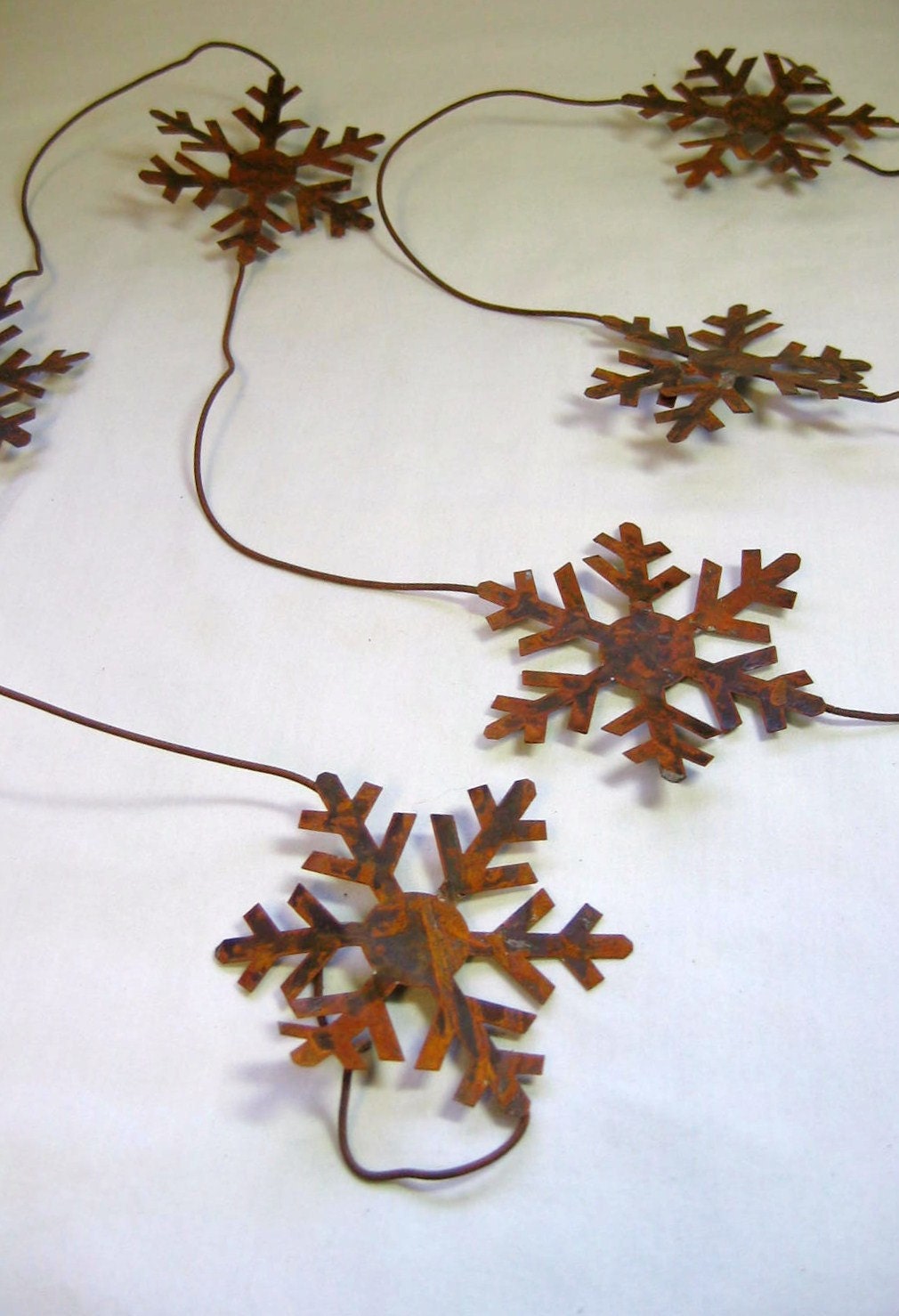 Rusty Tin Snowflake Garland 6 foot long with 3 and 3 quarters inch Snowflakes total of Six Snowflakes