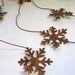 Rusty Tin Snowflake Garland 6 foot long with 3 and 3 quarters inch Snowflakes total of Six Snowflakes