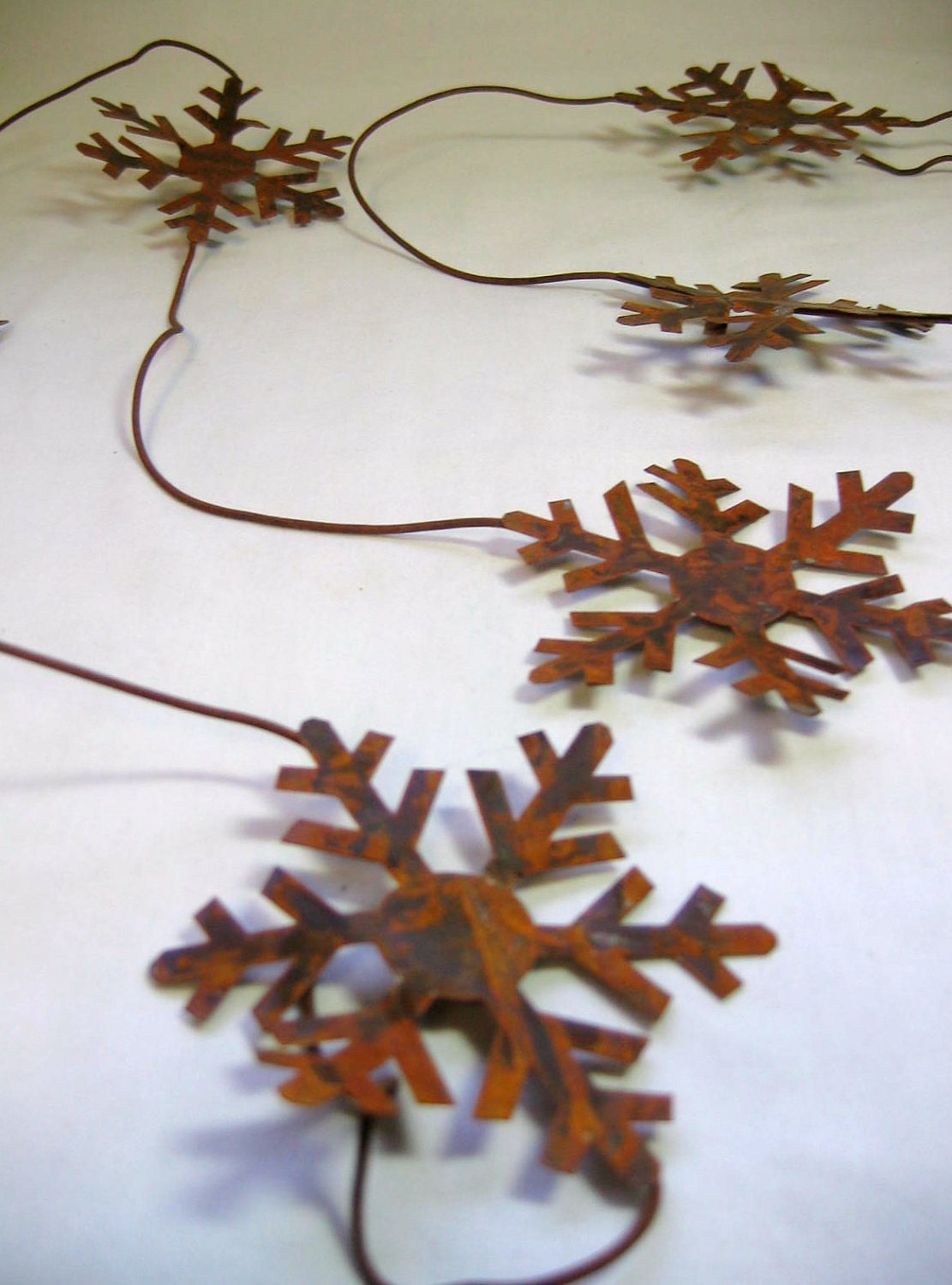 Rusty Tin Snowflake Garland 6 foot long with 3 and 3 quarters inch Snowflakes total of Six Snowflakes