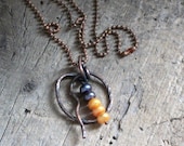 Copper necklace with pearls.