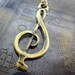 Antique Bronze Tone Metal Treble Clef Necklace