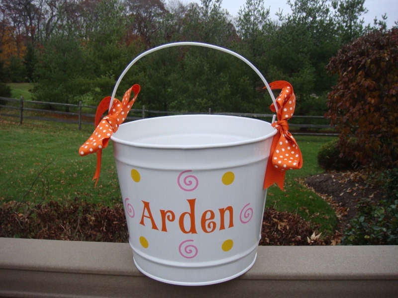 Personalized white metal bucket with orange pink and yellow designs and orange polka dot ribbon bow