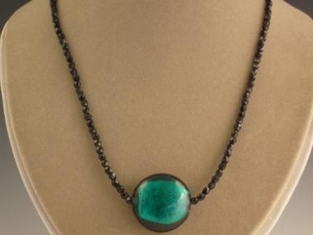 Jet necklace with teal glass foil coin pendant