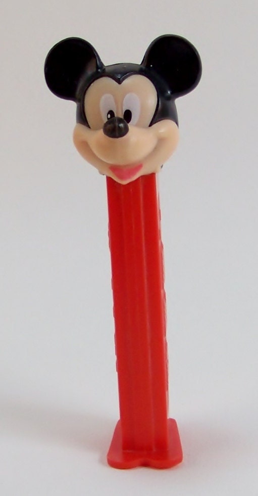 Five Mickey Mouse Collectibles Pez Dispenser, two Keyrings, Tomy car, and a stand up figure