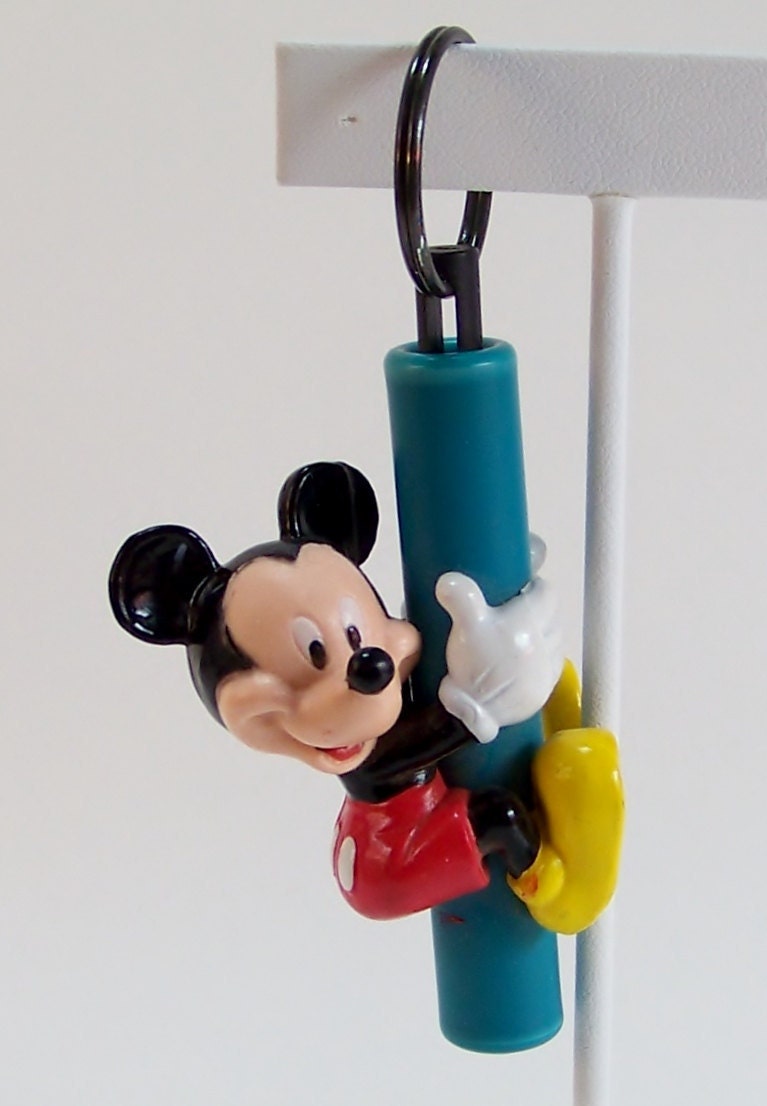 Five Mickey Mouse Collectibles Pez Dispenser, two Keyrings, Tomy car, and a stand up figure