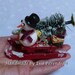 Miniature Christmas sledge with snowman, winter fantasy