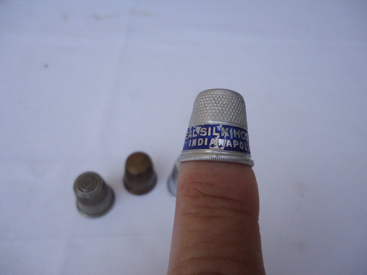 Four Thimbles for the Collector, One from a Silk Hosiery Mill, Even I am not old enough to have worn silk hosiery