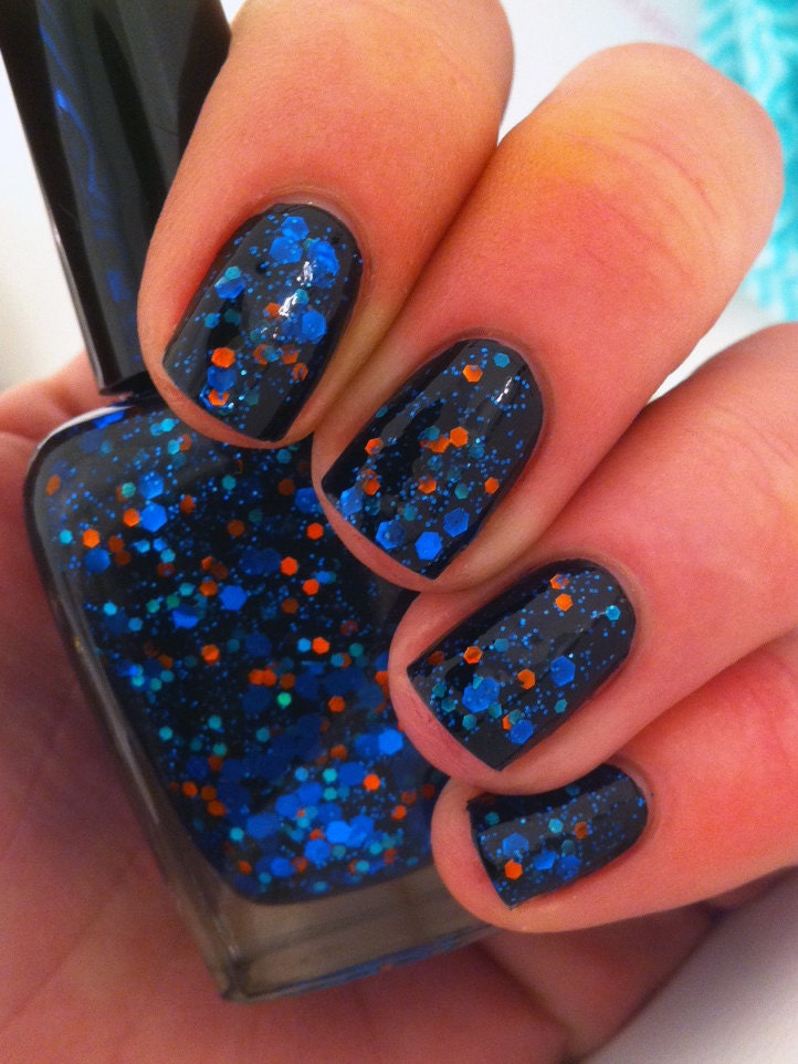 Nail polish - "When planets collide" bright blue glitter in a black jelly base