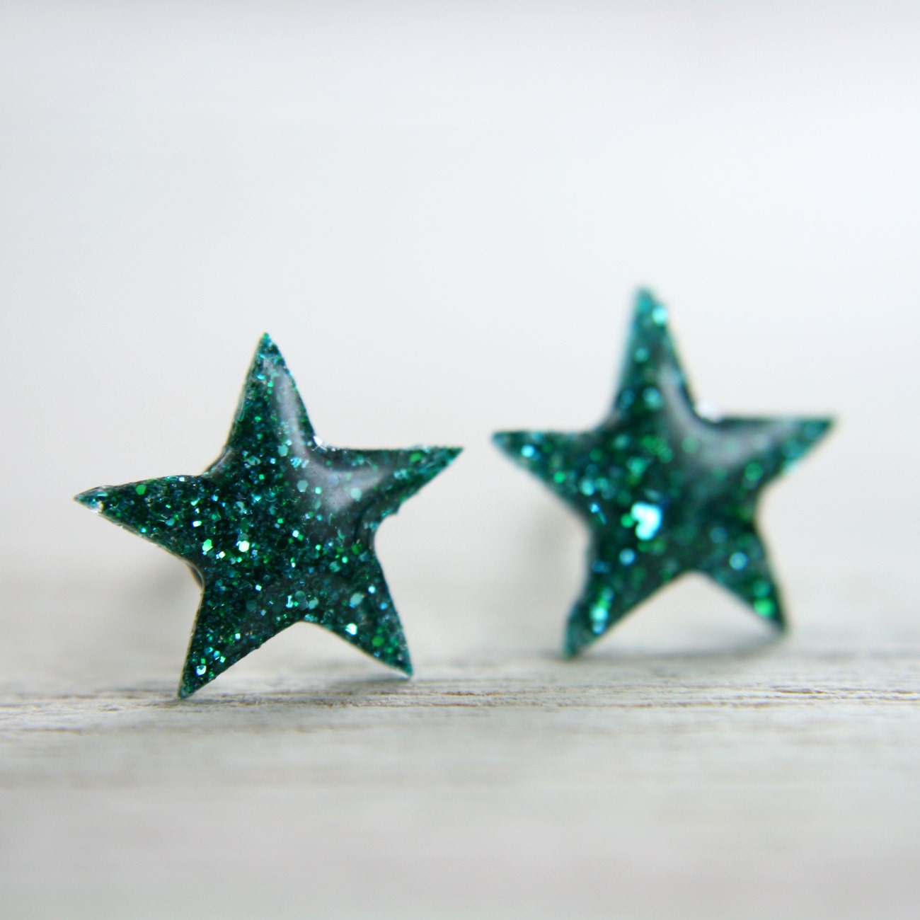 tiny star post earrings in green sparkles