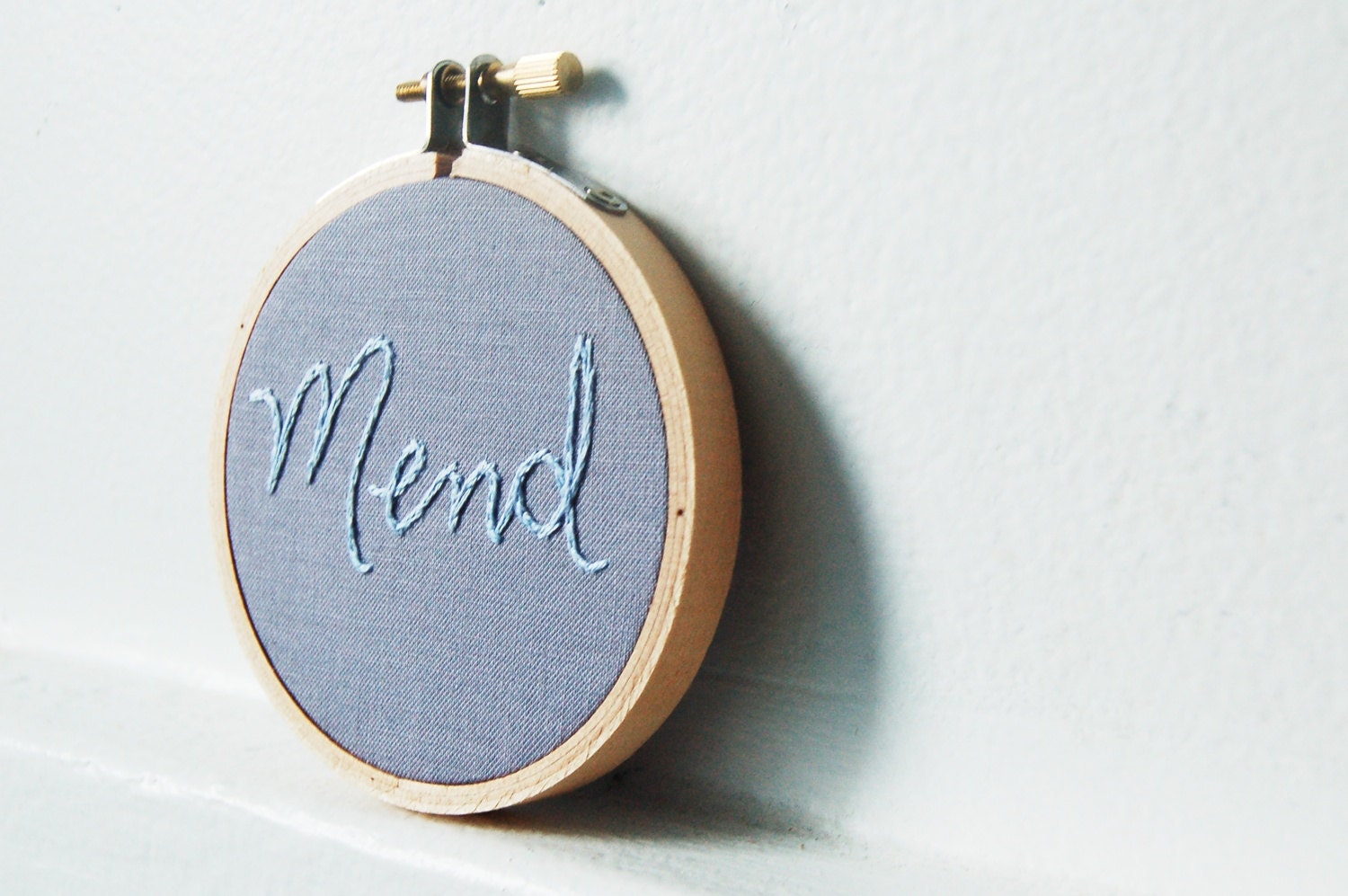 Hand Embroidered Wall Hanging in Hoop. "Mend" in Light Blue on Gray in 3 inch Hoop. Hand Stitched by merriweathercouncil on Etsy