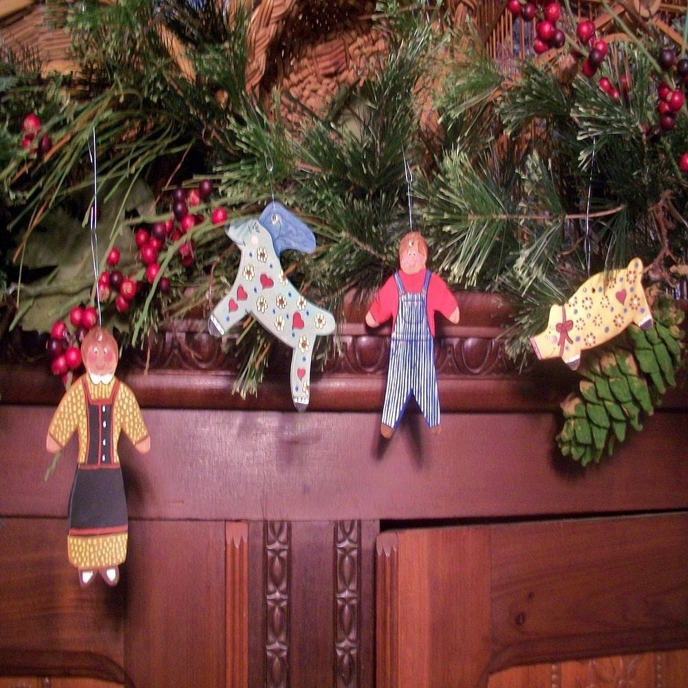 set of four hand-painted Christmas ornaments made of terra cotta