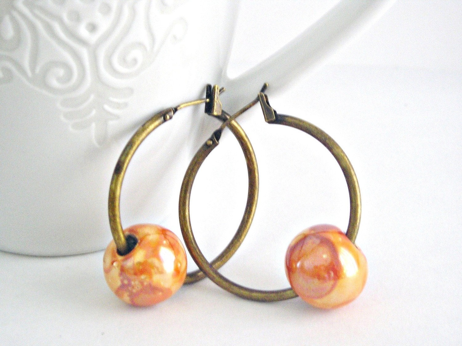 Orange ceramic beads in antique brass hook earrings