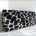 Black giraffe print clutch bag, Animal print fashion, Clutch purse.
