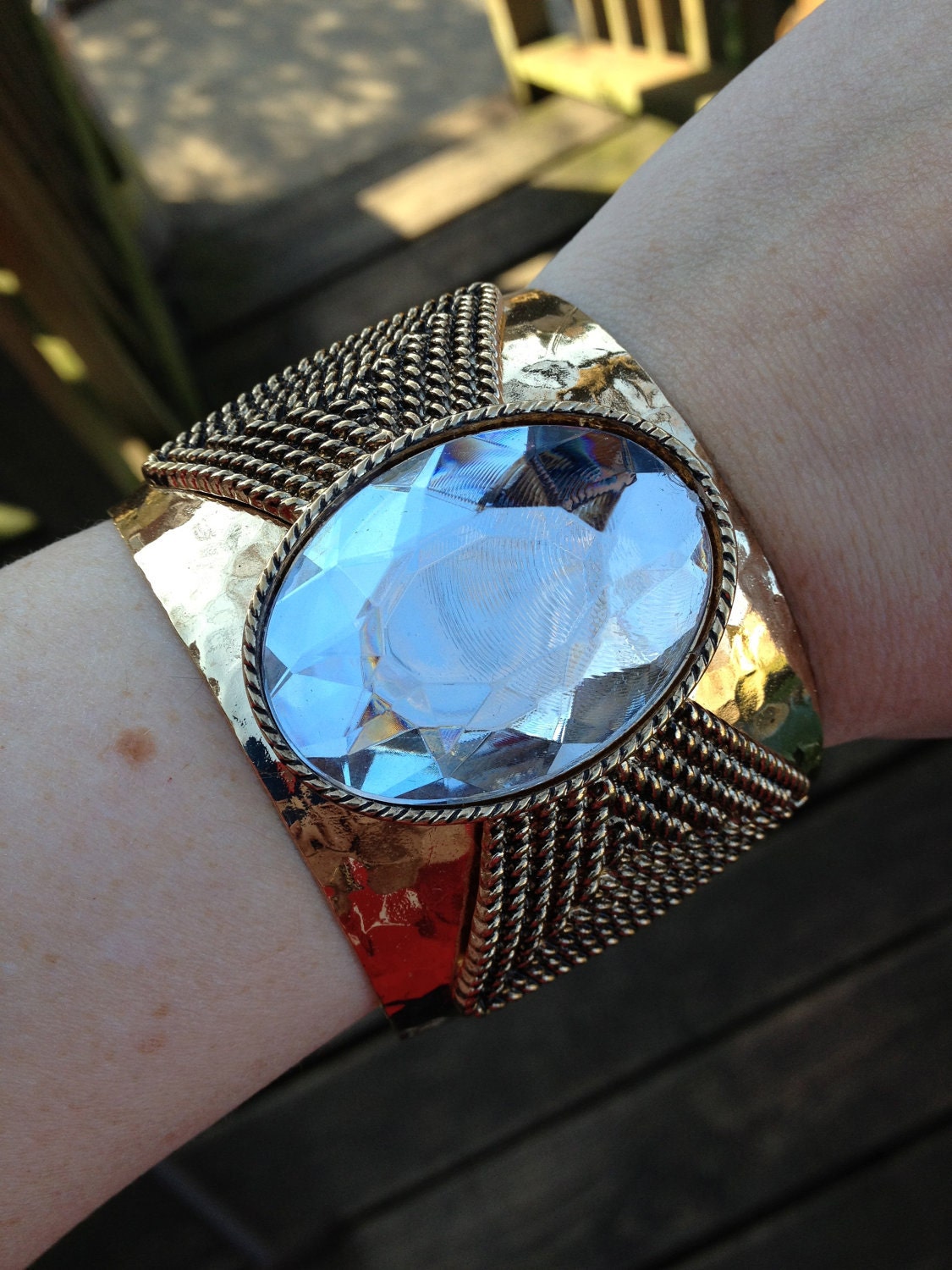 Huge vintage gold tone cuff bracelet with giant foiled back rhinestone