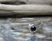 skinny stacking rings in sterling and black spinel on a hammered band