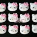 12 Glittery Hello Kitty Cabochons with a pink bow
