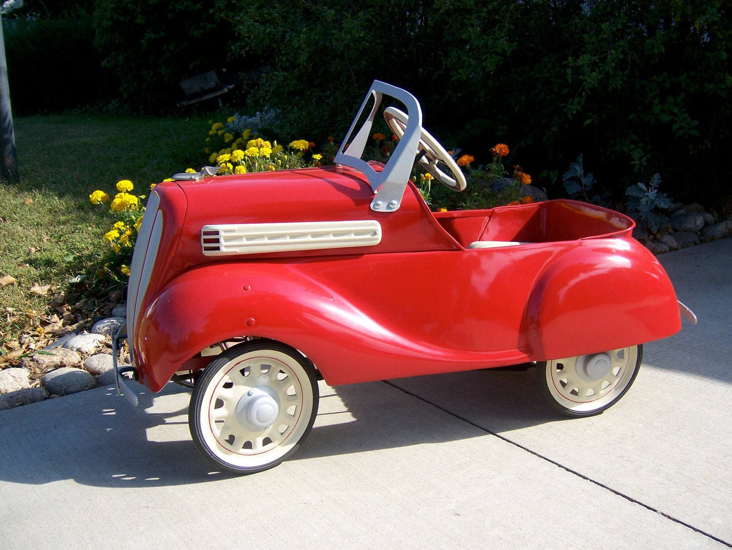 Vintage pedal car from mid to late 1930s in dazzling red now for sale. Original antique beautifully restored.