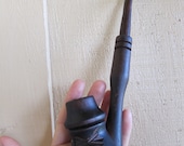 Vintage style wooden tobacco smoking pipe with a handcarved funny face and golden tooth.