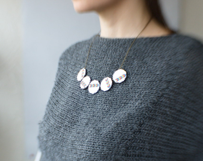 Textile necklace with five geometrical hand embroidered ornaments in bronze
