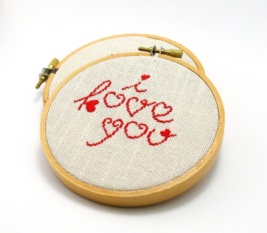 Cross stitch in wooden hoop I love you in red color