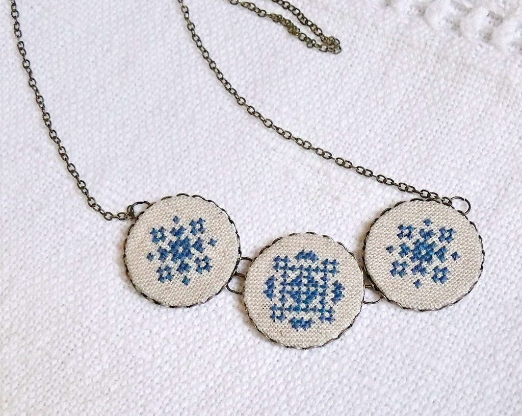 Cross stitch necklace with three navy blue ornament in bronze