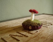 Felted red amanita mushroom in a dark red upcycled bottlecap
