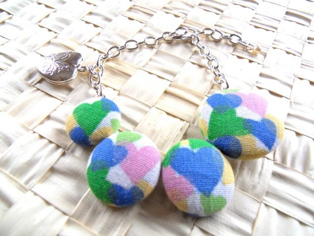 Chain bracelet with fabric buttons and fortune locket