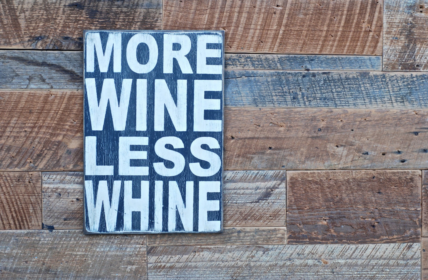 More wine less whine sign made from reclaimed plywood