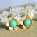 Tiffanys blue gold flower earrings - 14k gold plated earrings with real Turquoise swarovski pearls .