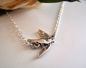 the bird in flight necklace.