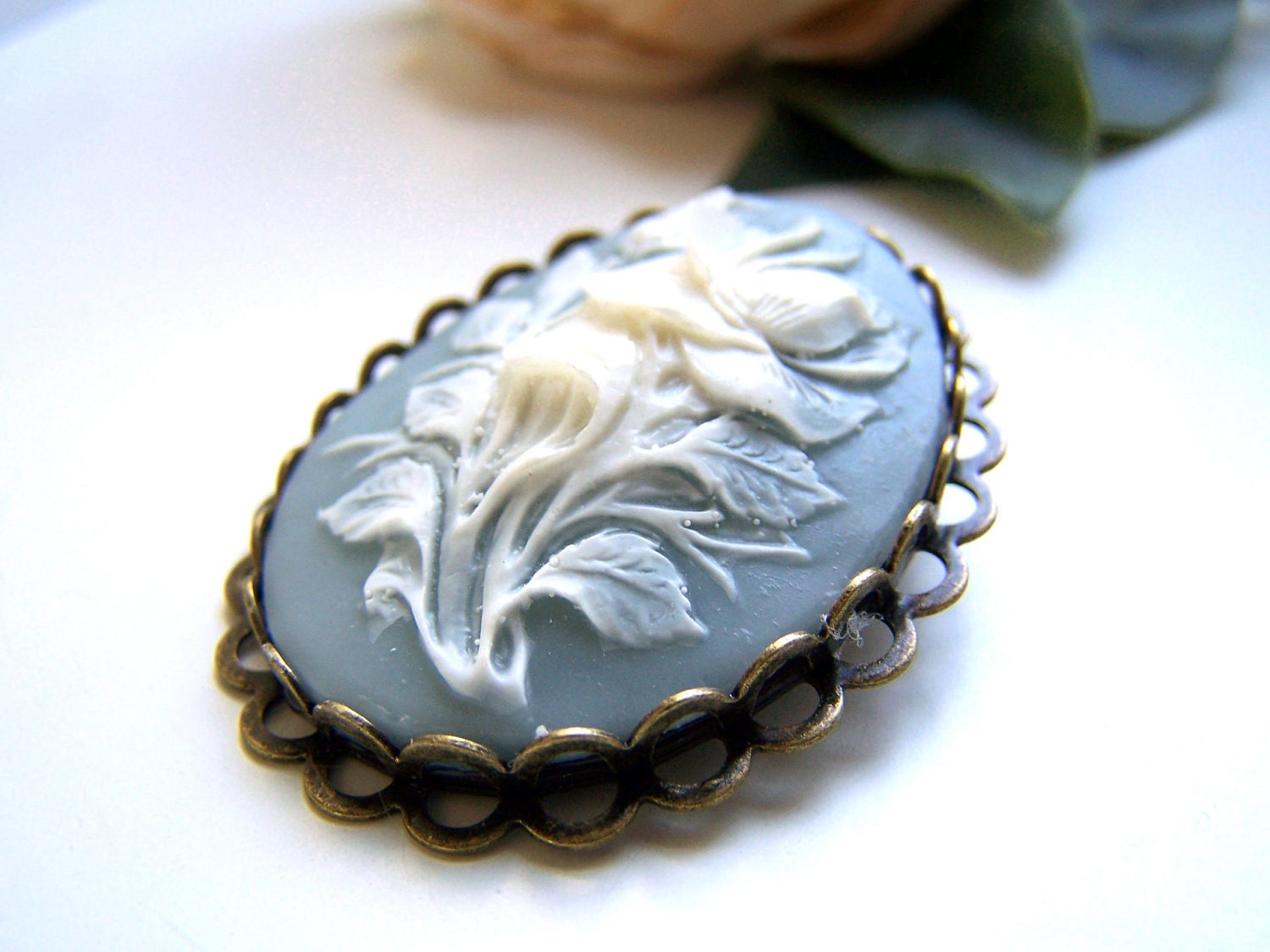 the light blue flower cameo brooch.